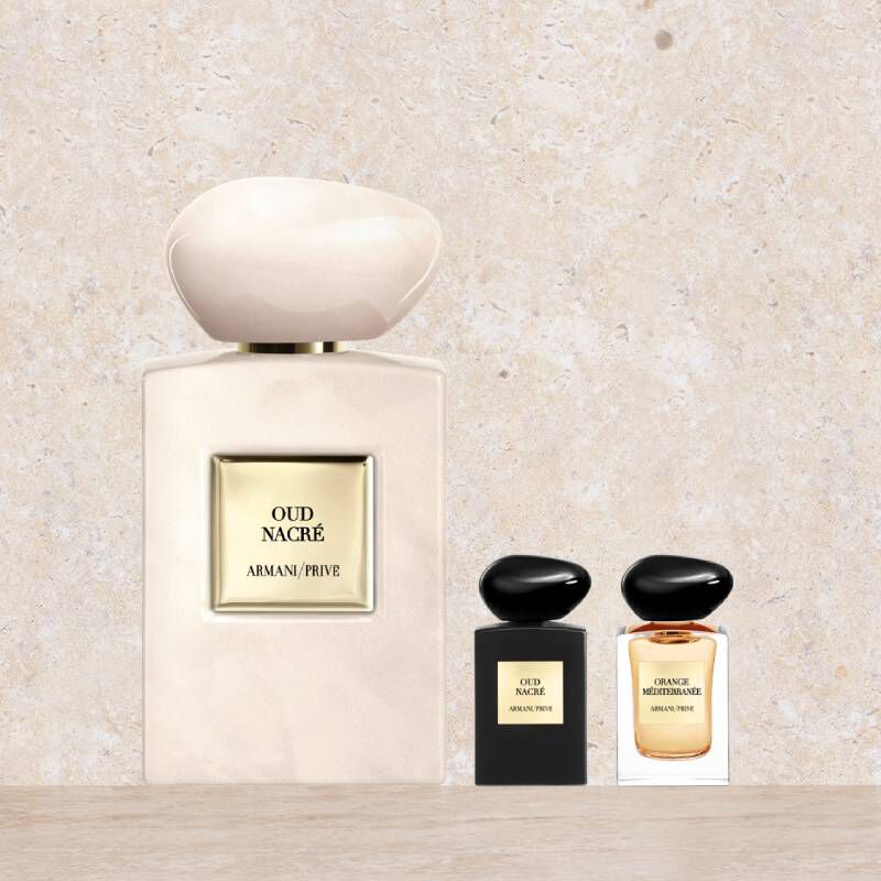 Drei Armani/Prive Parfumflaschen: eine große Oud Nacre in Perlmuttoptik und zwei Miniaturen (Oud Nacre und Orange Mediterranee).