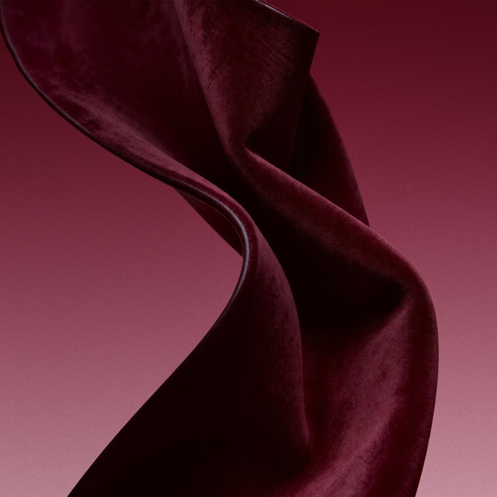 Burgundy fabric texture evoking the leather accord of Cuir Rubis.